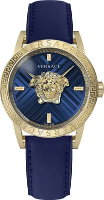 A close-up studio shot of a gold and blue Versace watch with a blue leather strap.