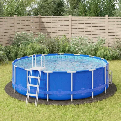 An above-ground swimming pool set up on a grassy lawn, with a wooden fence and bushes in the background.