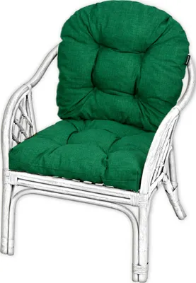 A white rattan chair with green cushions.
