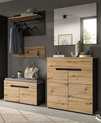 A modern entryway set with a bench, cabinet, and coat rack.