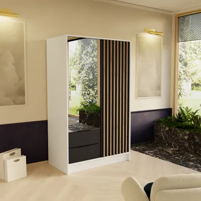 A modern bedroom or living room setting with a wardrobe, artwork, and plants.
