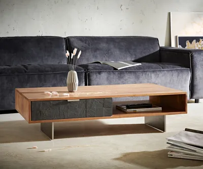 A modern living room scene featuring a coffee table in front of a sofa.
