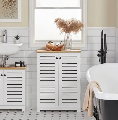 A bathroom scene with a sink, cabinet, and bathtub.