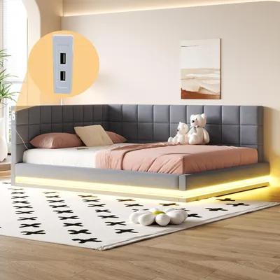 A modern bedroom with a gray upholstered bed frame featuring LED lighting and a USB charging port.