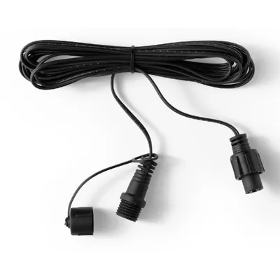 A black extension cable for Christmas lights, coiled and lying on a white background.