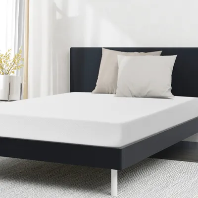 A mattress on a bed frame with two pillows.