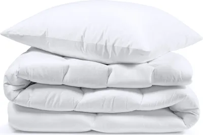 A white pillow and a folded white comforter are stacked on top of each other against a white background.