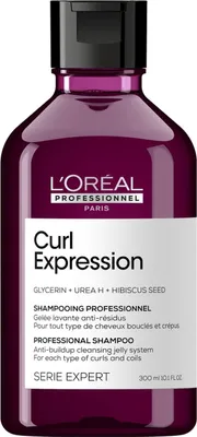A bottle of L'Oréal Professionnel Curl Expression shampoo against a white background.