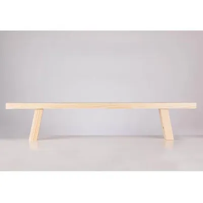A simple wooden bench on a white surface against a light gray background.