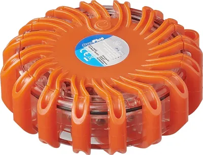 A close-up, studio shot of an orange emergency warning light with a label on top.