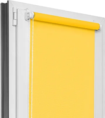 A close-up view of a yellow roller blind installed in a white window frame.