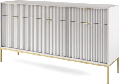 A white sideboard with ribbed fronts and gold legs, shown from a slight angle against a white background.