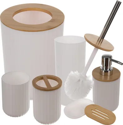 A collection of bathroom accessories, including a trash can, soap dispenser, toilet brush, toothbrush holder, soap dish, and cup, all with white bodies and bamboo accents.