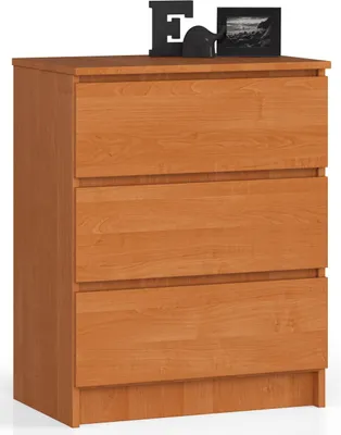 A three-drawer chest of drawers with decorative items on top.