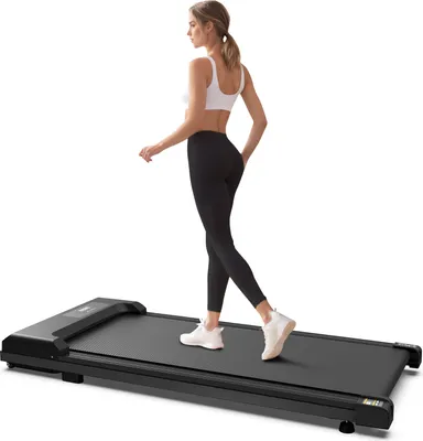 A woman is walking on a treadmill.