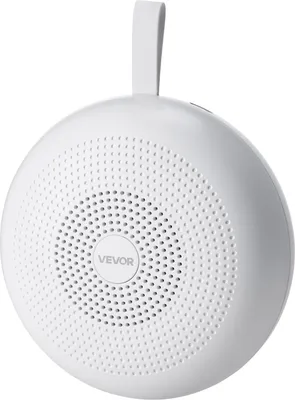 A white, spherical white noise machine with a handle on top.