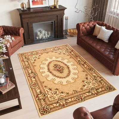 A living room scene with a fireplace, sofa, armchair, and a rug.