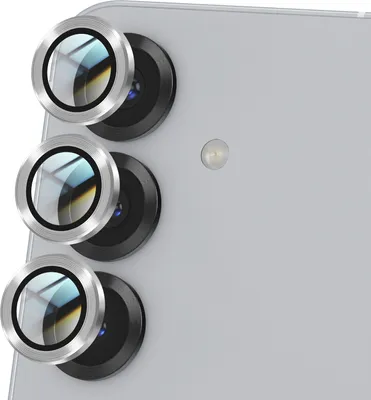 Close-up view of three camera lens protectors on the back of a light gray smartphone.