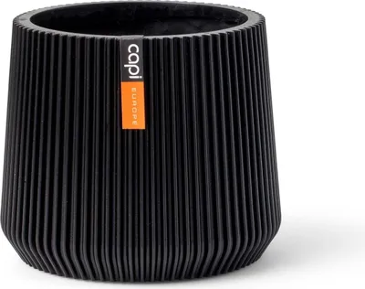 A black planter pot with a ribbed texture and an orange label.