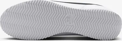 The image shows the sole of a white Nike Cortez sneaker with black accents.