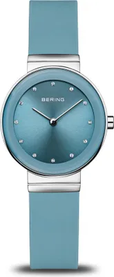 A close-up studio shot of a Bering women's watch with a blue silicone strap and a blue dial.