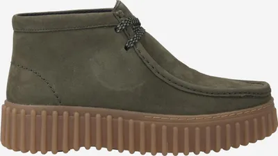 A side view of a green Clarks Torhill Moss boot with a thick brown sole.
