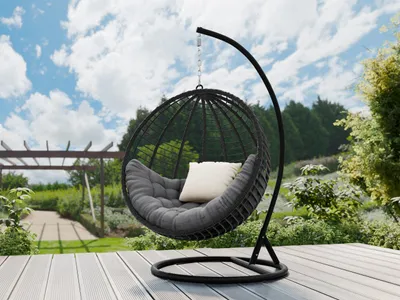 A hanging egg chair with cushions is placed on a wooden deck in a garden setting.