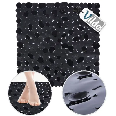 A black anti-slip bath mat with a pebble-like texture, shown with a close-up of feet on the mat and a close-up of the suction cups on the underside.