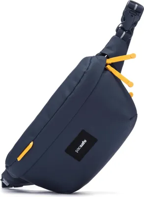 A blue sling pack bag with yellow zipper pulls and a black logo patch.