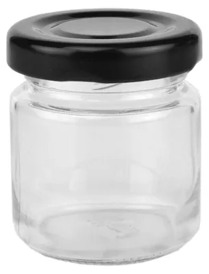 A clear studio shot of a small glass jar with a black lid.