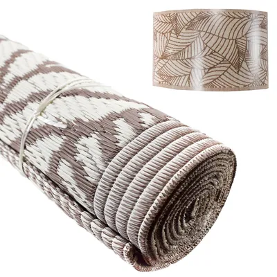 A rolled-up mat with a leaf pattern shown on a white background.