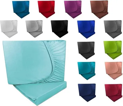 A collage of different colored fitted sheets, with a large teal fitted sheet in the foreground.