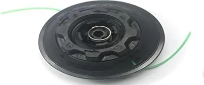 A close-up studio shot of a black string trimmer head with a green trimmer line.