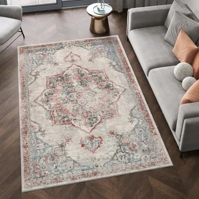 A living room scene with a rug, sofa, and side table.