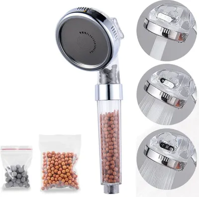 A shower head with filter beads and two small bags of filter beads are displayed against a white background.