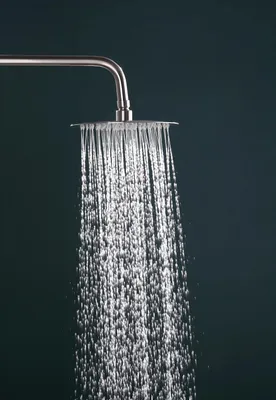 A close-up shot of a shower head with water flowing.