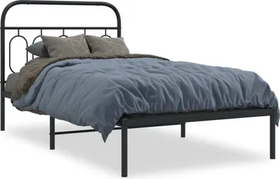 A black metal bed frame with a headboard and footboard, dressed with bedding and pillows, shown against a white background.