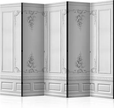 A white room divider with ornate paneling and decorative molding.