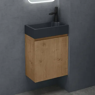 A modern wall-mounted bathroom vanity with a sink and faucet.