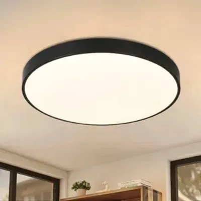 A modern, round LED ceiling light with a black frame and a white diffuser, mounted on a white ceiling.