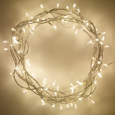 A circular arrangement of white string lights against a light beige background.