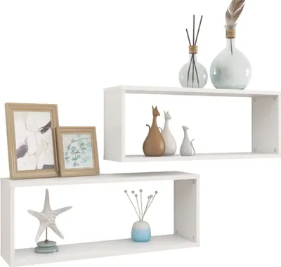 Two white cube shelves are displayed against a white background, each with decorative items.