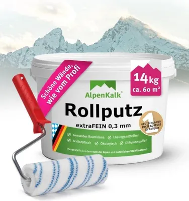A bucket of wall plaster with a paint roller in front of it, set against a backdrop of snowy mountains.