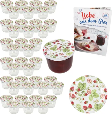 A collection of small glass jars with strawberry-themed lids, a single jar filled with jam, a recipe book, and a decorative plate, all arranged on a white background.