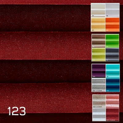 A collage of fabric swatches in various colors, with a large swatch of burgundy fabric in the foreground.