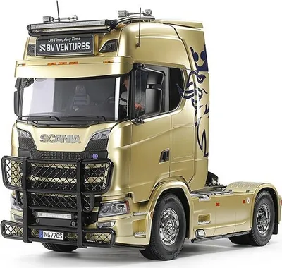 A gold RC truck with black accents and a bull bar.