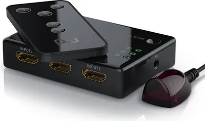 A black HDMI switch with a remote control and an IR receiver is shown on a white background.