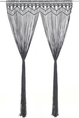 A pair of dark grey macrame curtains hanging against a white background.
