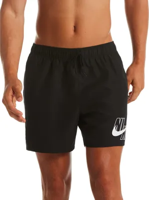 A person wearing black Nike swim shorts.