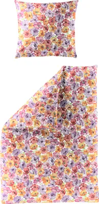 A pillow and a folded duvet cover with a floral pattern.